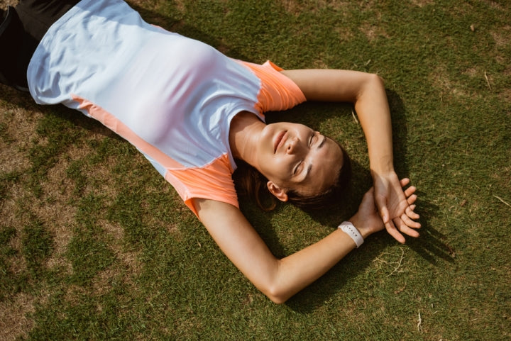 Girl resting on the ground after an extensive workout