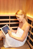 Woman sitting in Clearlight infrared sauna