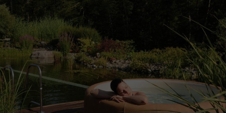 background image of a woman relaxing and resting her head on the side of her softub hot tub